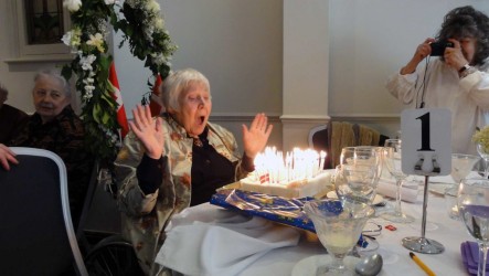 Karen blowing out the candles at her 90th birthday party at the Packford Hotel in Woodford Green