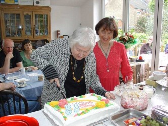 Karen cutting her cake given to her by the WEA group for her 88th birthday, 2009