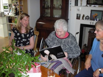Karen receiving a commemorative album celebrating the 40th anniversary of the TCC, given to her by the TCC Foundation