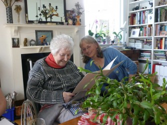 Karen with Frances Lennard, looking at the signed card marking the 40th anniversary of the TCC, 2015