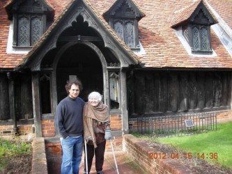 Karen with her grandson Jacob outside Greensted Church near Chipping Ongar, 2012