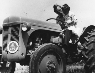 Norman and Katrina on a tractor, c. 1954