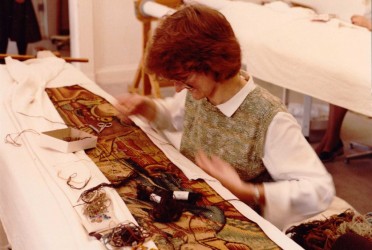 Student works on a tapestry in the workroom at the TCC, 1985